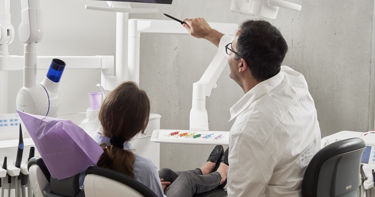 Clear Invisalign aligner being held up to demonstrate transparency